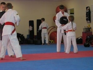 Karate-class-Brighton-Hill-Basingstoke-Junior-Coaches-with-Kids-hitting-pads-and-bags.